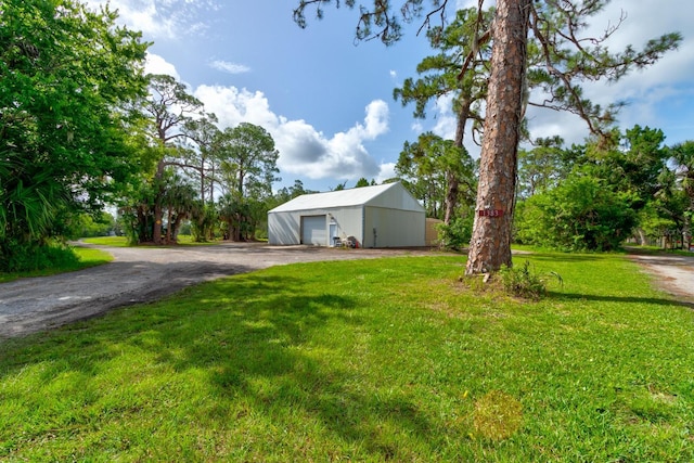1383 Tumblin Dr, New Smyrna Beach, FL 32168 - view of grassy yard with a garage, an outbuilding, a pole building, and driveway