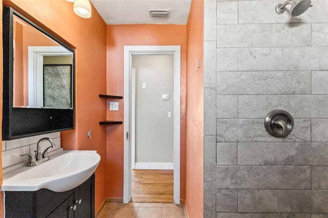 505 Wisteria Rd, Daytona Beach, FL 32118 - full bathroom featuring vanity, tiled shower, and tile patterned flooring