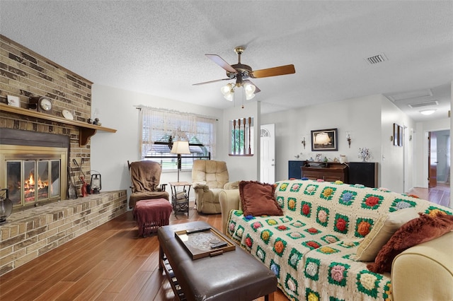 270 Sandyhook Ln, Deland, FL 32724 - living area featuring wood finished floors, a fireplace, a textured ceiling, and ceiling fan