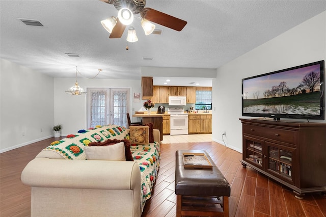 270 Sandyhook Ln, Deland, FL 32724 - living area with light wood-style flooring, ceiling fan, a textured ceiling, a chandelier, and recessed lighting