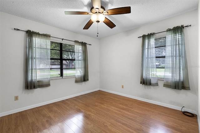 270 Sandyhook Ln, Deland, FL 32724 - spare room with plenty of natural light, wood finished floors, a ceiling fan, and a textured ceiling