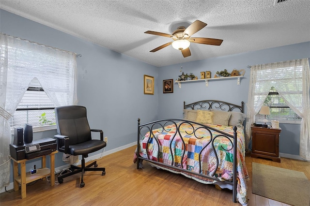 270 Sandyhook Ln, Deland, FL 32724 - bedroom with wood finished floors, a textured ceiling, and ceiling fan