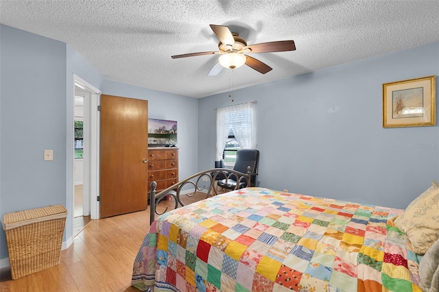 270 Sandyhook Ln, Deland, FL 32724 - bedroom with wood finished floors, a textured ceiling, and ceiling fan