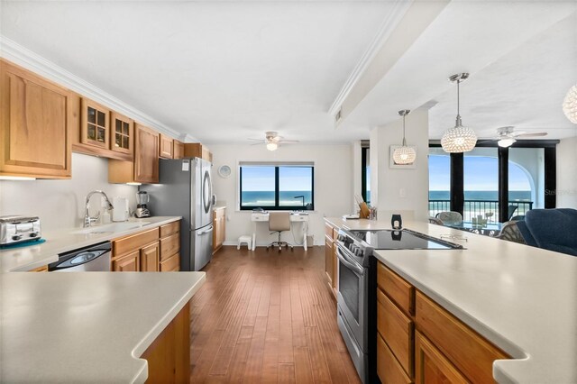 3003 S Atlantic Ave Unit 3A2, Daytona Beach Shores, FL 32118 - kitchen featuring appliances with stainless steel finishes, a ceiling fan, light countertops, glass insert cabinets, and ornamental molding