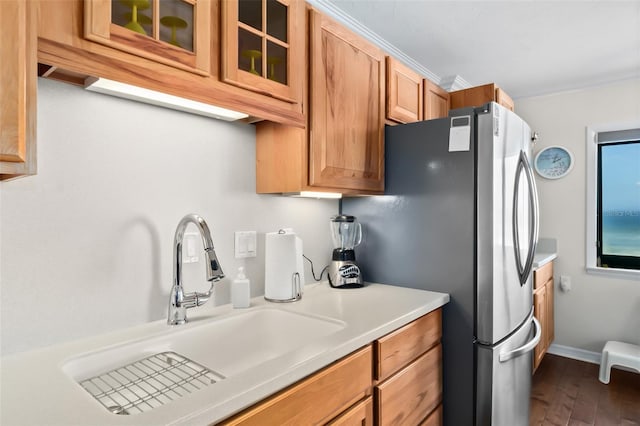 3003 S Atlantic Ave Unit 3A2, Daytona Beach Shores, FL 32118 - kitchen featuring glass insert cabinets, dark wood-style flooring, light countertops, brown cabinetry, and freestanding refrigerator