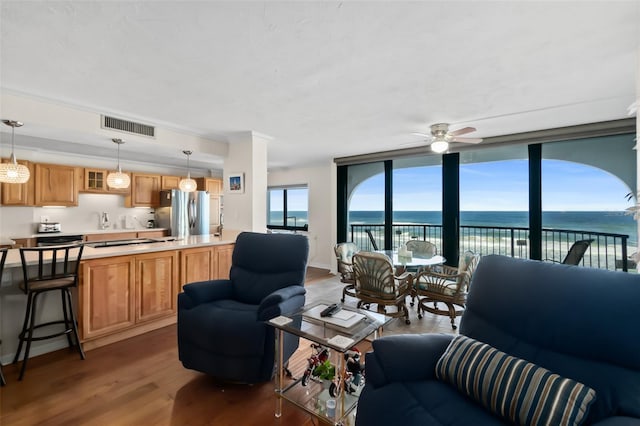 3003 S Atlantic Ave Unit 3A2, Daytona Beach Shores, FL 32118 - living room with a ceiling fan, wood finished floors, and a water view