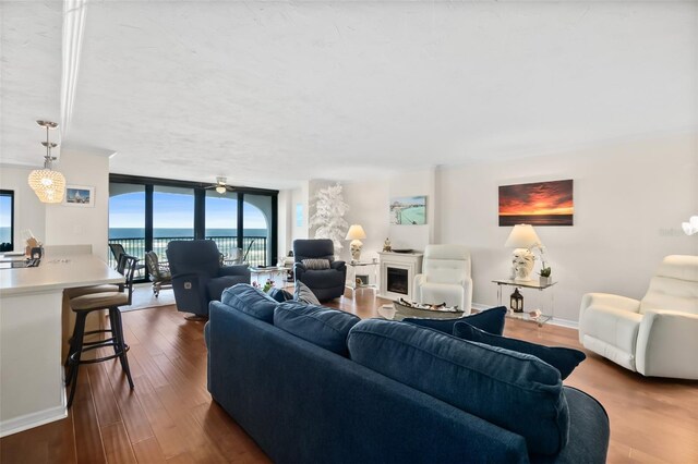 3003 S Atlantic Ave Unit 3A2, Daytona Beach Shores, FL 32118 - living area featuring floor to ceiling windows, dark wood-type flooring, and a fireplace