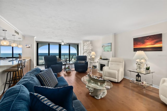 3003 S Atlantic Ave Unit 3A2, Daytona Beach Shores, FL 32118 - living room featuring wood finished floors, ornamental molding, floor to ceiling windows, and a water view