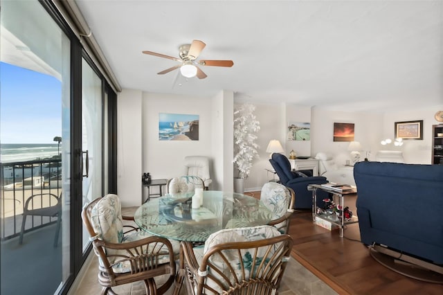 3003 S Atlantic Ave Unit 3A2, Daytona Beach Shores, FL 32118 - dining room featuring a ceiling fan and a water view