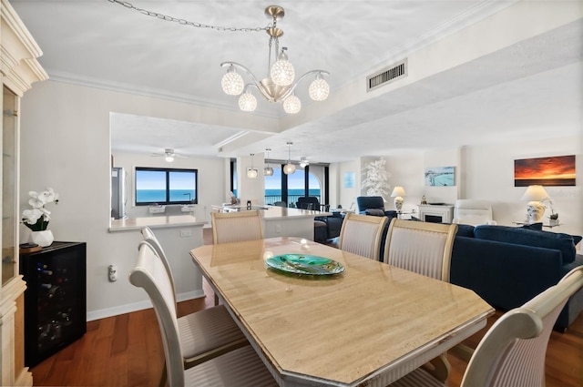 3003 S Atlantic Ave Unit 3A2, Daytona Beach Shores, FL 32118 - dining area featuring a chandelier, dark wood finished floors, and crown molding