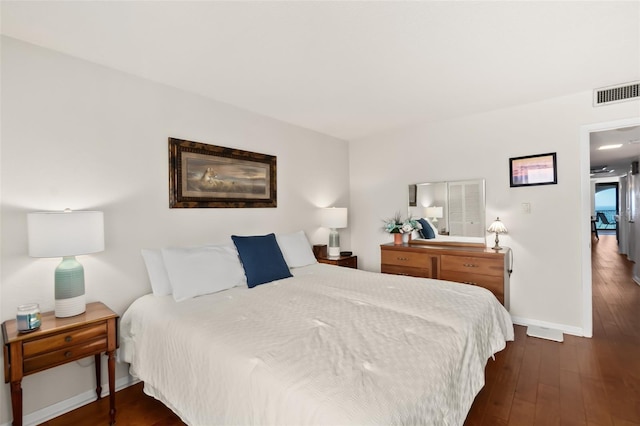 3003 S Atlantic Ave Unit 3A2, Daytona Beach Shores, FL 32118 - bedroom with dark wood finished floors and baseboards