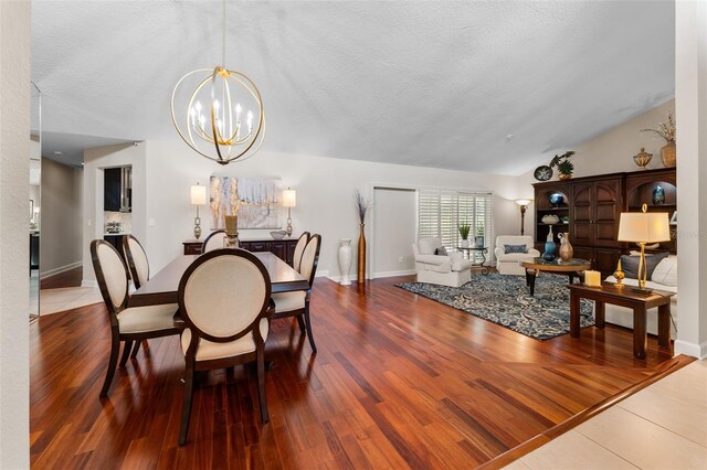 3 Pine Meadow Ct, Debary, FL 32713 - dining room featuring a chandelier, a textured ceiling, wood finished floors, and lofted ceiling