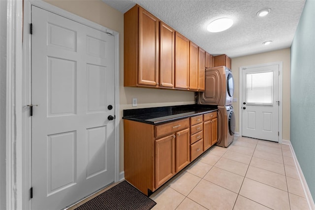 3 Pine Meadow Ct, Debary, FL 32713 - washroom with stacked washer / dryer, cabinet space, light tile patterned floors, and a textured ceiling