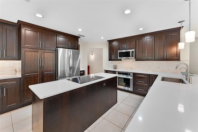 3 Pine Meadow Ct, Debary, FL 32713 - kitchen with appliances with stainless steel finishes, a kitchen island, light tile patterned floors, light countertops, and recessed lighting