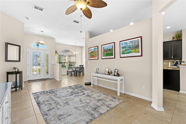 727 Grape Ivy Ln, New Smyrna Beach, FL 32168 - entryway featuring light tile patterned floors, ceiling fan, recessed lighting, and a chandelier
