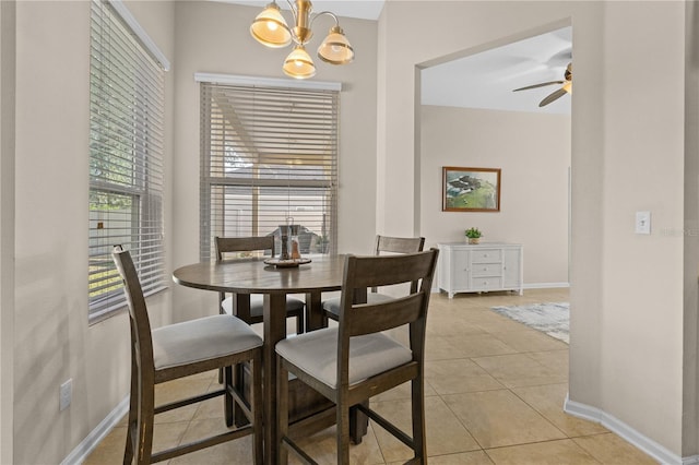 727 Grape Ivy Ln, New Smyrna Beach, FL 32168 - dining area with a chandelier, ceiling fan, and light tile patterned floors