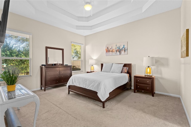 727 Grape Ivy Ln, New Smyrna Beach, FL 32168 - bedroom with light colored carpet, a raised ceiling, and a ceiling fan