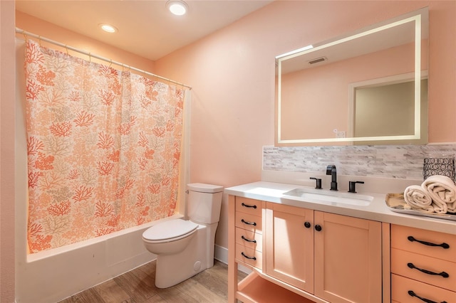 2724 N Halifax Ave, Daytona Beach, FL 32118 - bathroom with vanity, decorative backsplash, wood finished floors, shower / bath combo with shower curtain, and recessed lighting
