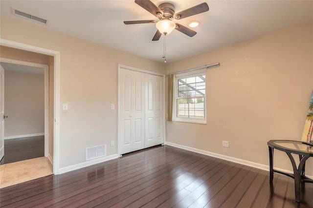 2724 N Halifax Ave, Daytona Beach, FL 32118 - unfurnished bedroom featuring dark wood-style floors, a closet, and a ceiling fan
