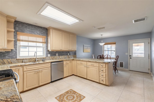2724 N Halifax Ave, Daytona Beach, FL 32118 - kitchen with stainless steel appliances, a peninsula, backsplash, and light brown cabinets