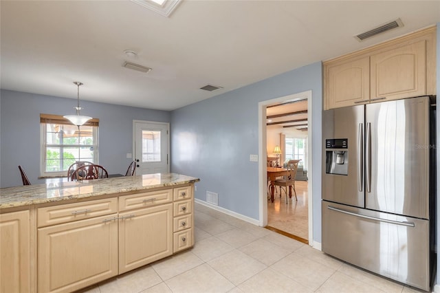 2724 N Halifax Ave, Daytona Beach, FL 32118 - kitchen with stainless steel fridge with ice dispenser, plenty of natural light, and light stone countertops