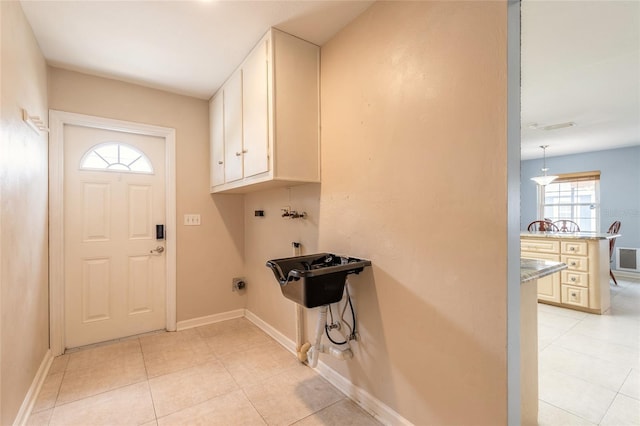 2724 N Halifax Ave, Daytona Beach, FL 32118 - washroom featuring cabinet space, hookup for a washing machine, hookup for an electric dryer, and light tile patterned floors