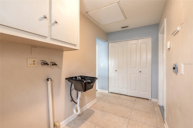 2724 N Halifax Ave, Daytona Beach, FL 32118 - laundry area featuring cabinet space, hookup for a washing machine, and light tile patterned flooring