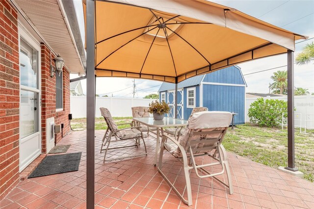 2724 N Halifax Ave, Daytona Beach, FL 32118 - view of patio featuring outdoor dining area, a gazebo, and a shed