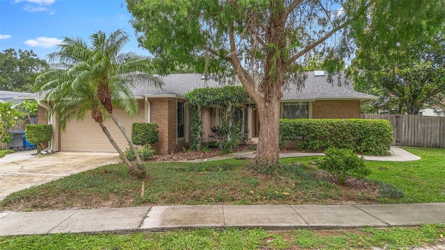 1261 Burning Tree Ln, Winter Park, FL 32792 - view of front of property featuring a garage, brick siding, driveway, and roof with shingles