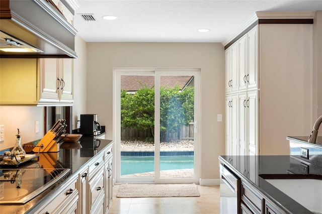 1261 Burning Tree Ln, Winter Park, FL 32792 - kitchen featuring stainless steel dishwasher, black electric stovetop, wall chimney range hood, light tile patterned flooring, and recessed lighting