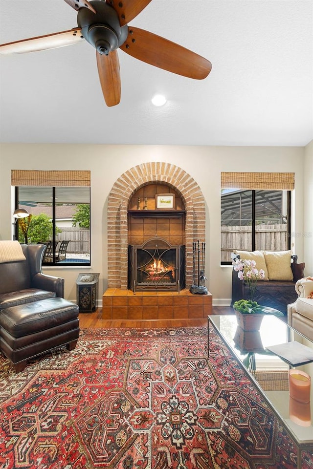 1261 Burning Tree Ln, Winter Park, FL 32792 - living area with wood finished floors, ceiling fan, a fireplace, and recessed lighting