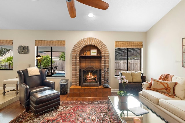 1261 Burning Tree Ln, Winter Park, FL 32792 - living room featuring wood finished floors, ceiling fan, a brick fireplace, plenty of natural light, and recessed lighting