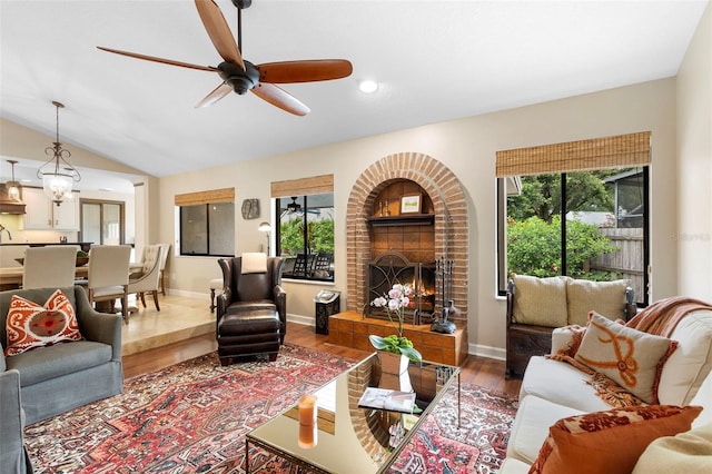 1261 Burning Tree Ln, Winter Park, FL 32792 - living area featuring ceiling fan, wood finished floors, a fireplace, and lofted ceiling