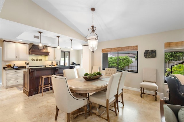 1261 Burning Tree Ln, Winter Park, FL 32792 - dining space featuring vaulted ceiling and light tile patterned flooring