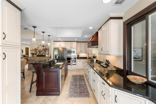 1261 Burning Tree Ln, Winter Park, FL 32792 - kitchen featuring appliances with stainless steel finishes, custom exhaust hood, recessed lighting, a breakfast bar area, and decorative light fixtures