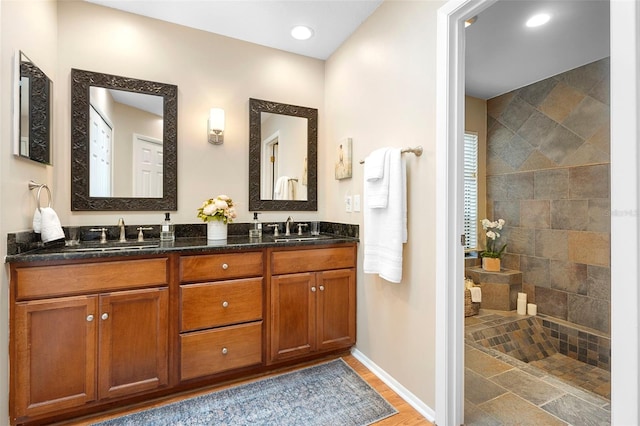 1261 Burning Tree Ln, Winter Park, FL 32792 - full bathroom with double vanity, a walk in shower, and recessed lighting