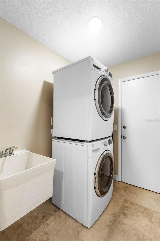 1261 Burning Tree Ln, Winter Park, FL 32792 - washroom featuring estacked washer and dryer and a textured ceiling