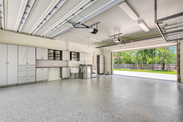 3428 Longleaf Rd, Ormond Beach, FL 32174 - garage featuring washing machine and clothes dryer and a garage door opener