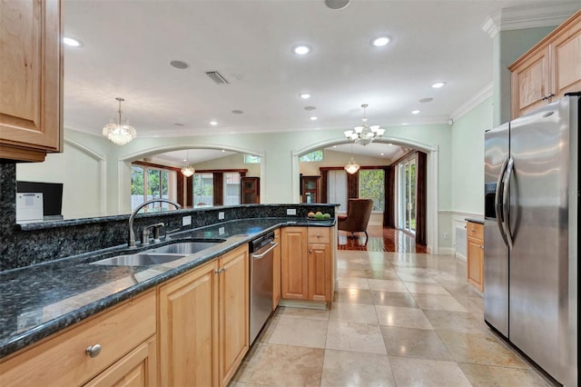 3428 Longleaf Rd, Ormond Beach, FL 32174 - kitchen featuring appliances with stainless steel finishes, a chandelier, crown molding, arched walkways, and decorative backsplash