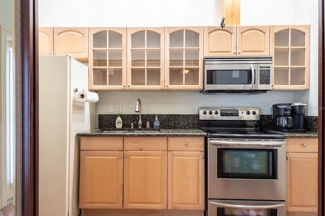 3428 Longleaf Rd, Ormond Beach, FL 32174 - kitchen with appliances with stainless steel finishes, light brown cabinetry, and glass insert cabinets