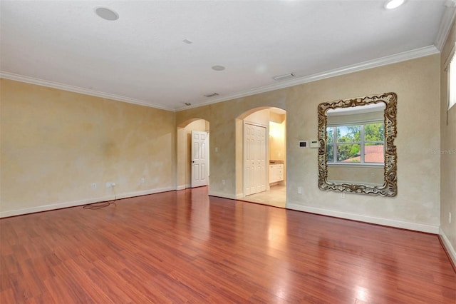 3428 Longleaf Rd, Ormond Beach, FL 32174 - empty room featuring arched walkways, wood finished floors, and crown molding