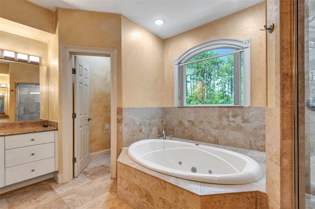 3428 Longleaf Rd, Ormond Beach, FL 32174 - bathroom with vanity, a tub with jets, and a textured wall