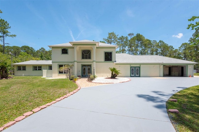 3428 Longleaf Rd, Ormond Beach, FL 32174 - mediterranean / spanish-style house featuring stucco siding, concrete driveway, and a front yard