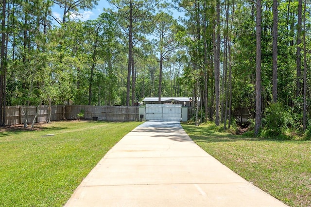 3428 Longleaf Rd, Ormond Beach, FL 32174 - view of yard featuring a gate and concrete driveway