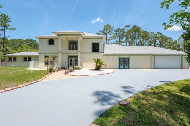 3428 Longleaf Rd, Ormond Beach, FL 32174 - mediterranean / spanish home featuring stucco siding, concrete driveway, a garage, and a front lawn
