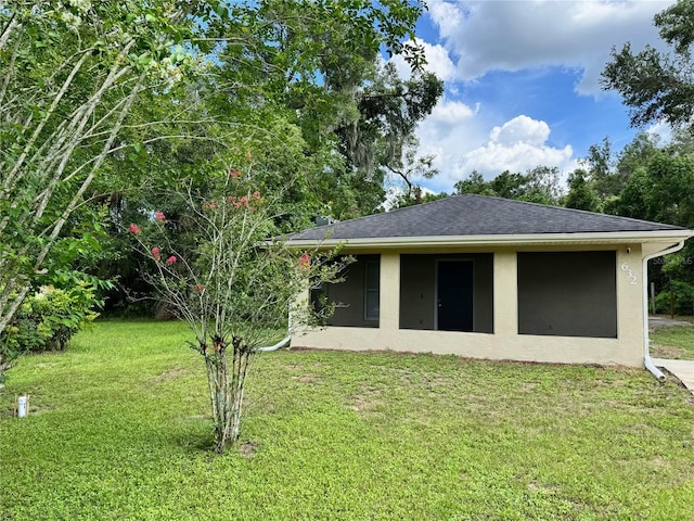 632 W Hubbard Ave, Deland, FL 32720 - rear view of house featuring a lawn, stucco siding, and a shingled roof