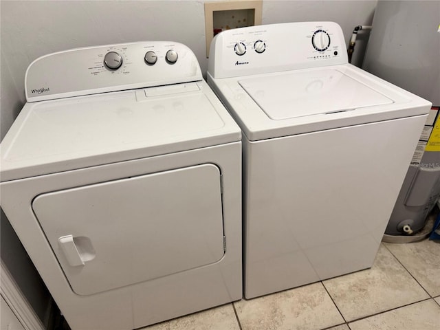 632 W Hubbard Ave, Deland, FL 32720 - laundry room featuring washer and dryer, water heater, and light tile patterned floors