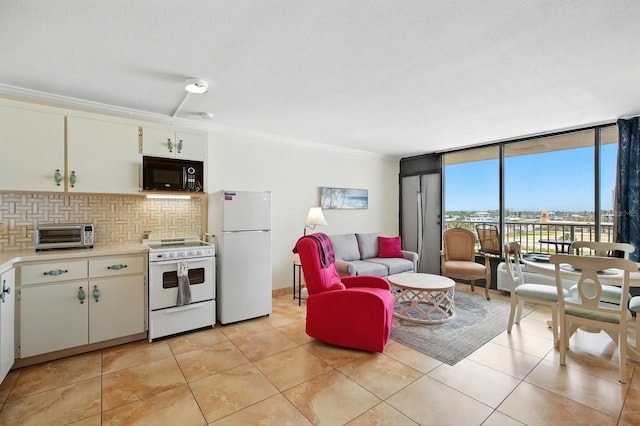 2043 S Atlantic Ave Unit 520, Daytona Beach, FL 32118 - kitchen with white appliances, light countertops, backsplash, light tile patterned floors, and expansive windows