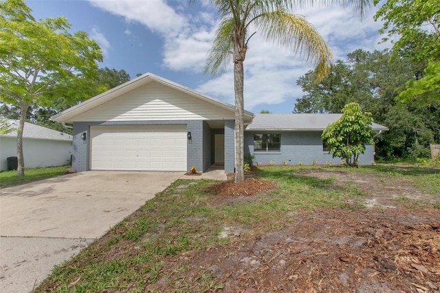 3117 Pine Tree Dr, Edgewater, FL 32141 - view of front facade featuring a garage, brick siding, and driveway