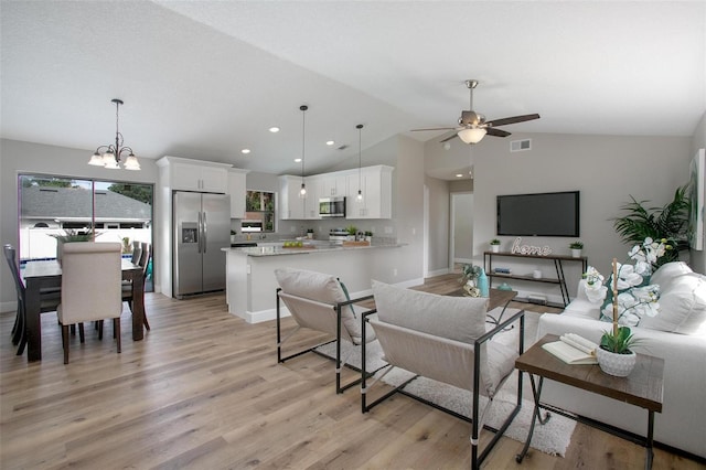 3117 Pine Tree Dr, Edgewater, FL 32141 - living area with vaulted ceiling, a ceiling fan, light wood finished floors, a chandelier, and recessed lighting